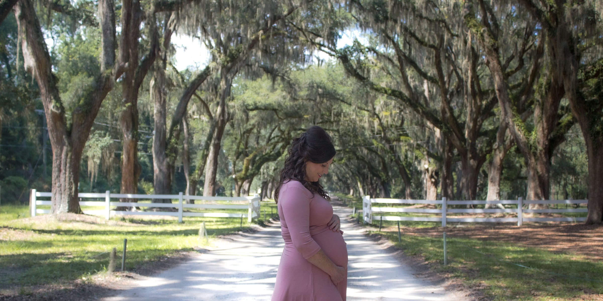 Dr. Nicole McDonald walking through a tree-lined driveway
